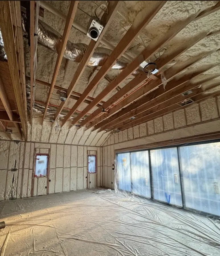 Interior walls and ceiling insulated with spray foam during new construction in North Lakes
